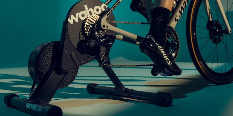 Side view of interactive smart bike trainer with a complete bicycle for indoor training.
