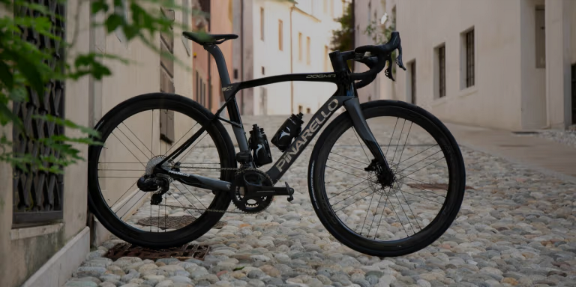 Pinarello Dogma X endurance road bike with premium carbon frame, side view.