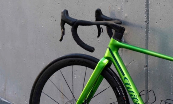 Close-up of the integrated carbon handlebar and lightweight aero cockpit setup on the Wilier Verticale SLR Hulk Green complete bicycle by Cicli Corsa.