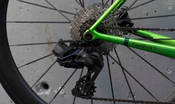 Campagnolo Super Record Wireless 13-speed electronic rear derailleur and cassette on the Wilier Verticale SLR Hulk Green complete bicycle by Cicli Corsa.