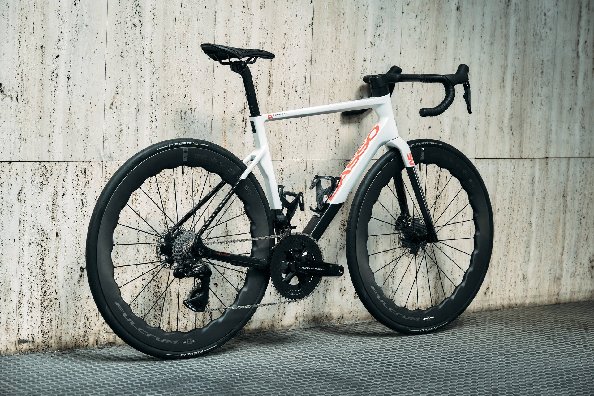 Rear view of the Basso SV custom aero road complete bicycle highlighting the Fulcrum Sharq wavy carbon wheels and elite drivetrain upgrades, tailor-made by Cicli Corsa.