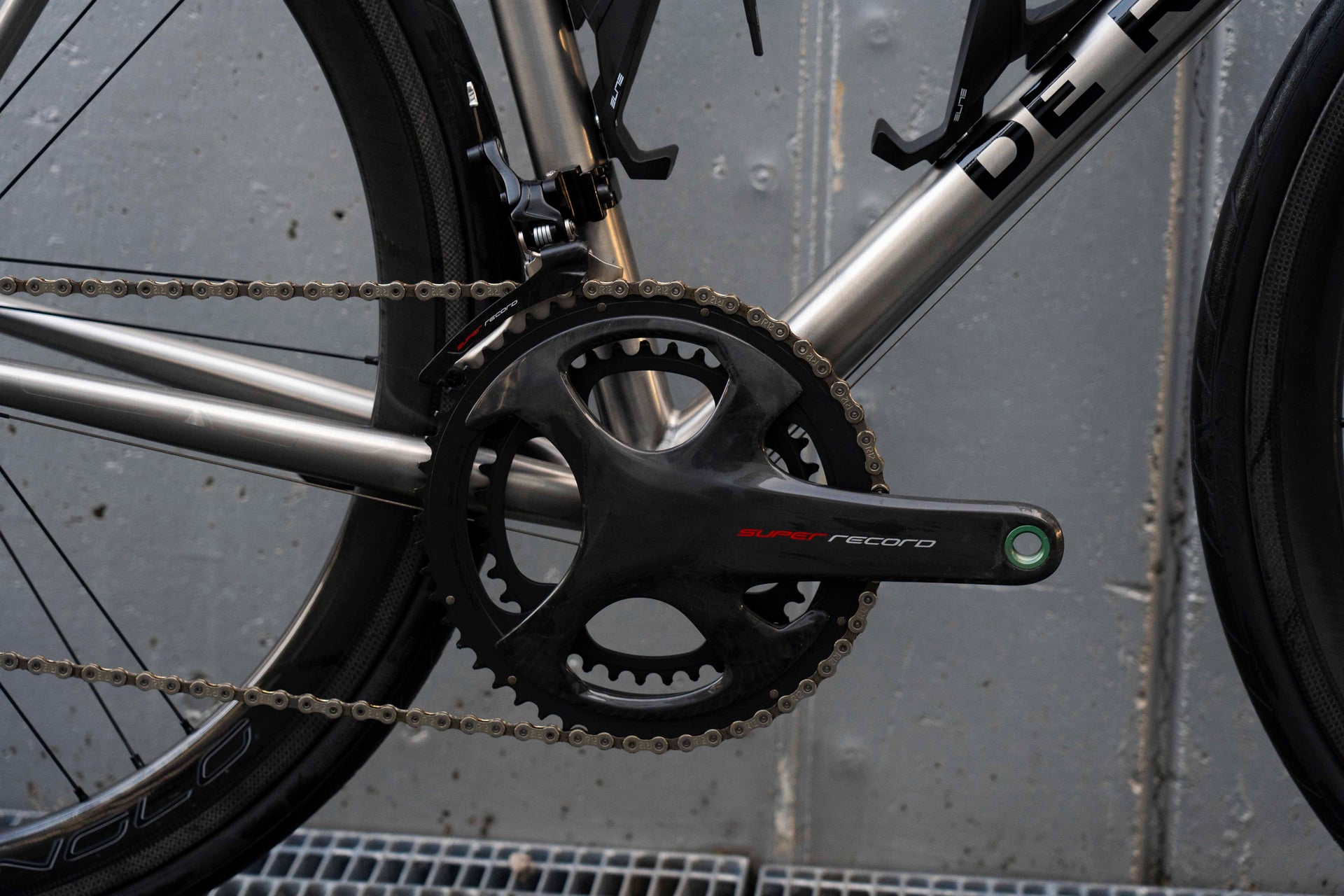 Campagnolo Super Record carbon road crankset close-up on the luxury De Rosa Solo Titanio complete bicycle by Cicli Corsa.