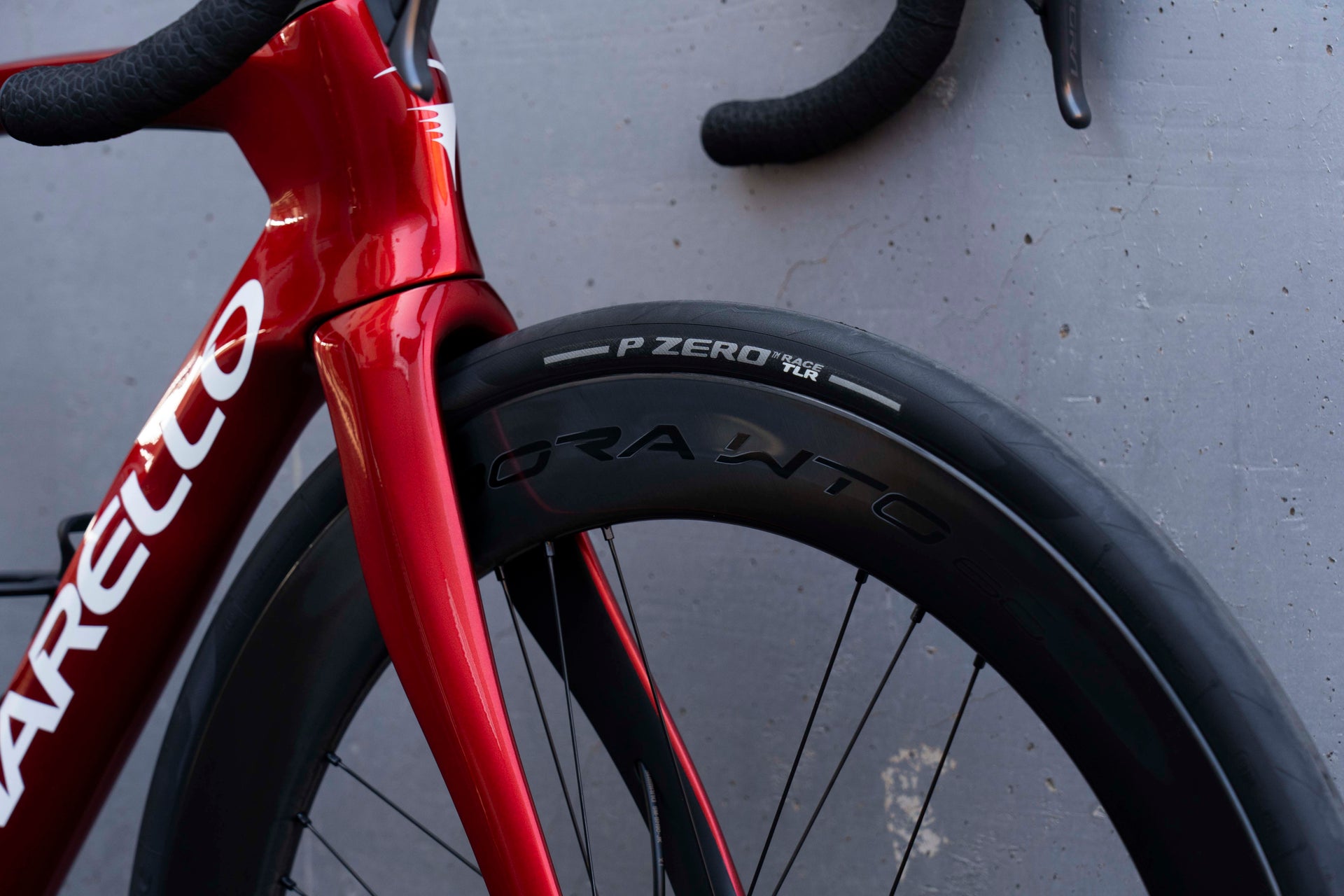 Campagnolo Bora WTO 60 deep-section carbon wheels and premium road tires on the Pinarello Dogma F Starry Red complete bicycle by Cicli Corsa.
