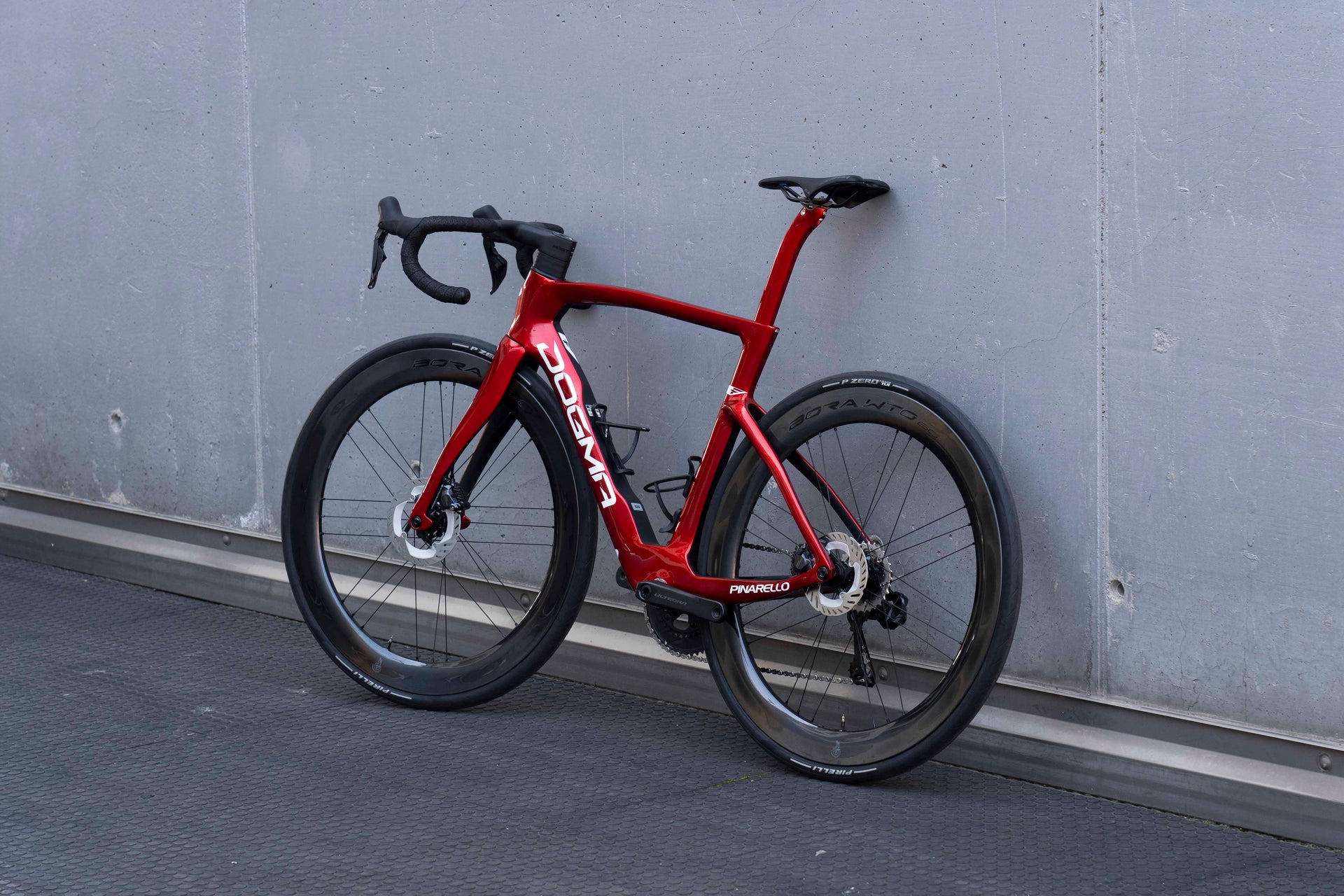 Non-drive side view of the Pinarello Dogma F premium carbon complete road bicycle featuring deep-section Campagnolo wheels, assembled by Cicli Corsa.