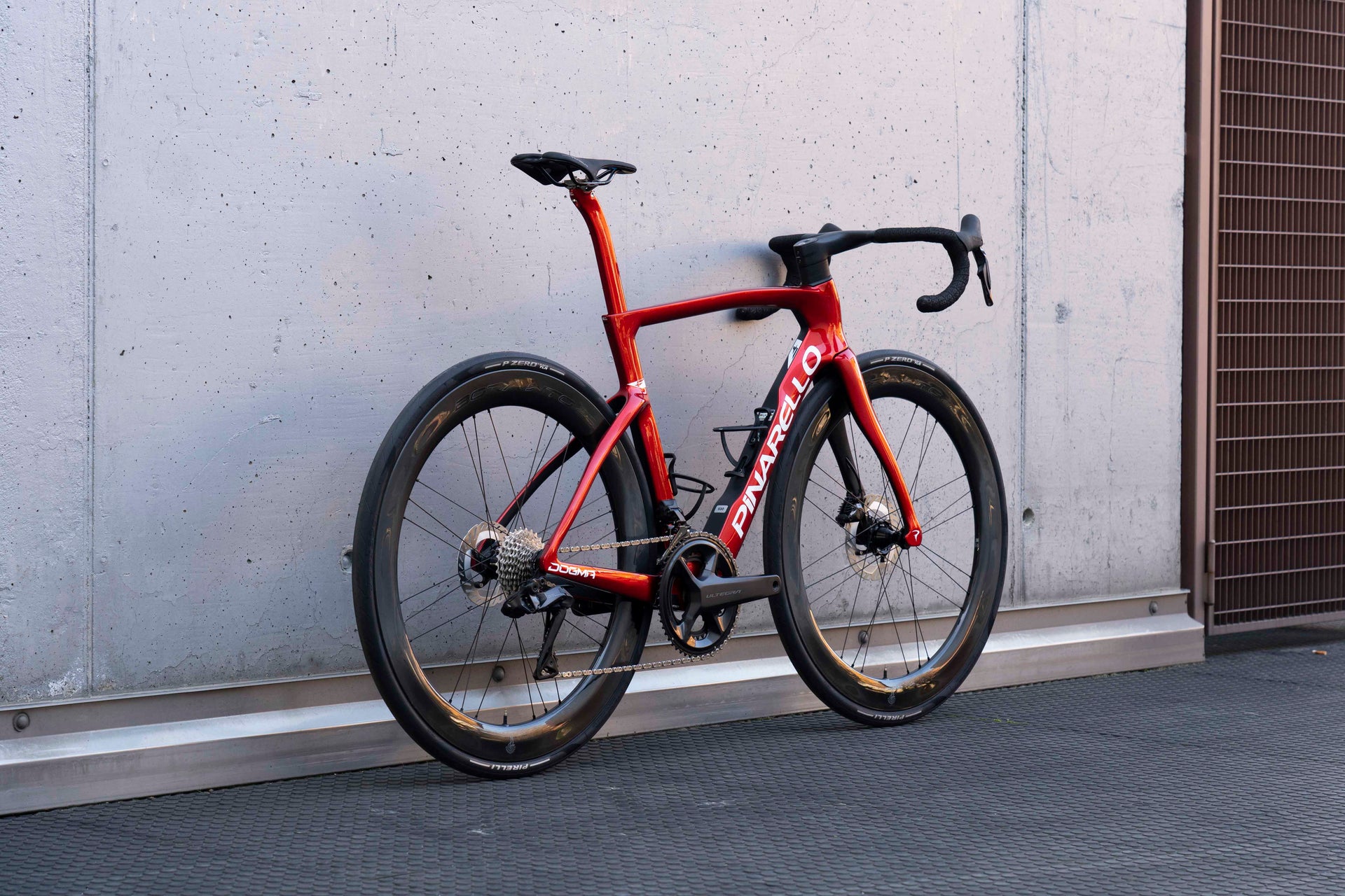 Rear view of the Pinarello Dogma F custom road complete bicycle highlighting the aerodynamic frame design and Campagnolo wheelset, tailor-made by Cicli Corsa.