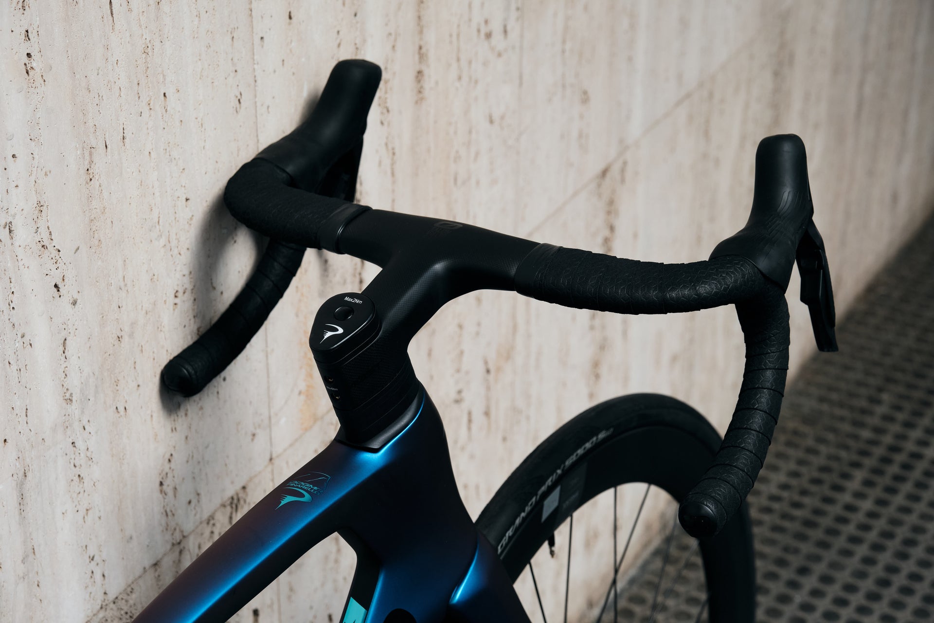 Close-up of the integrated MOST carbon handlebar and aero cockpit on the Pinarello Dogma F Luxter Blue complete bicycle by Cicli Corsa.