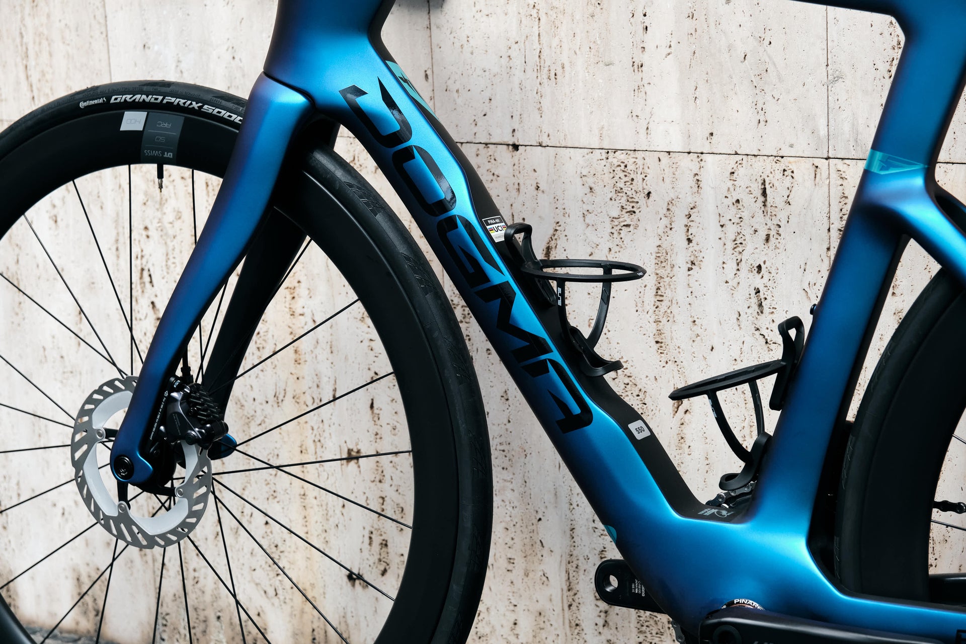 Pinarello branding on the down tube highlighting the premium Luxter Blue metallic paint finish on the Dogma F complete bicycle by Cicli Corsa.