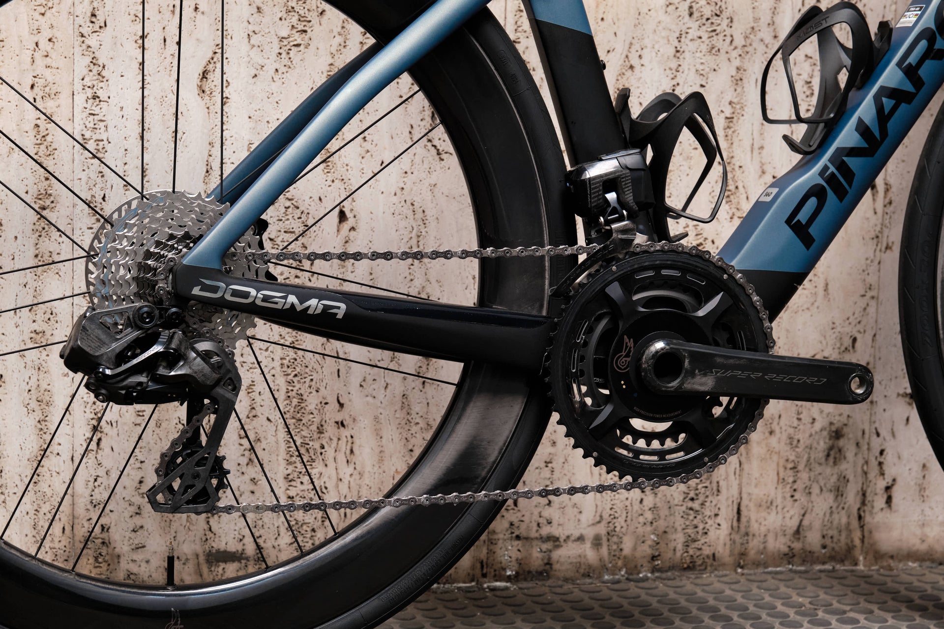 Campagnolo Super Record Wireless carbon road crankset with integrated power meter close-up on the premium Pinarello Dogma F complete bicycle by Cicli Corsa.