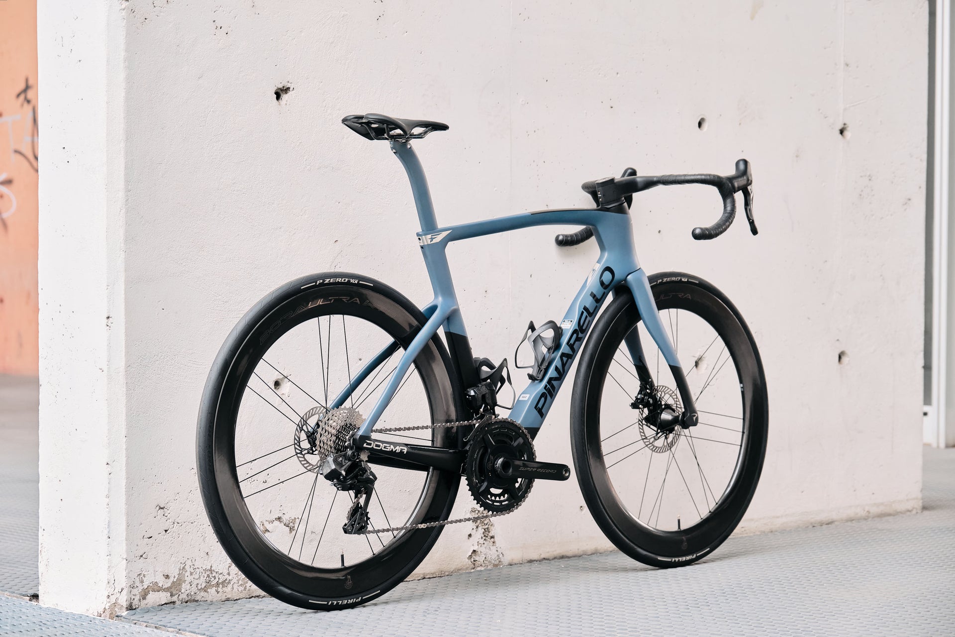 Rear view of the Pinarello Dogma F custom road complete bicycle highlighting the aerodynamic frame design and Bora Ultra WTO 60 Chrome wheelset, tailor-made by Cicli Corsa.