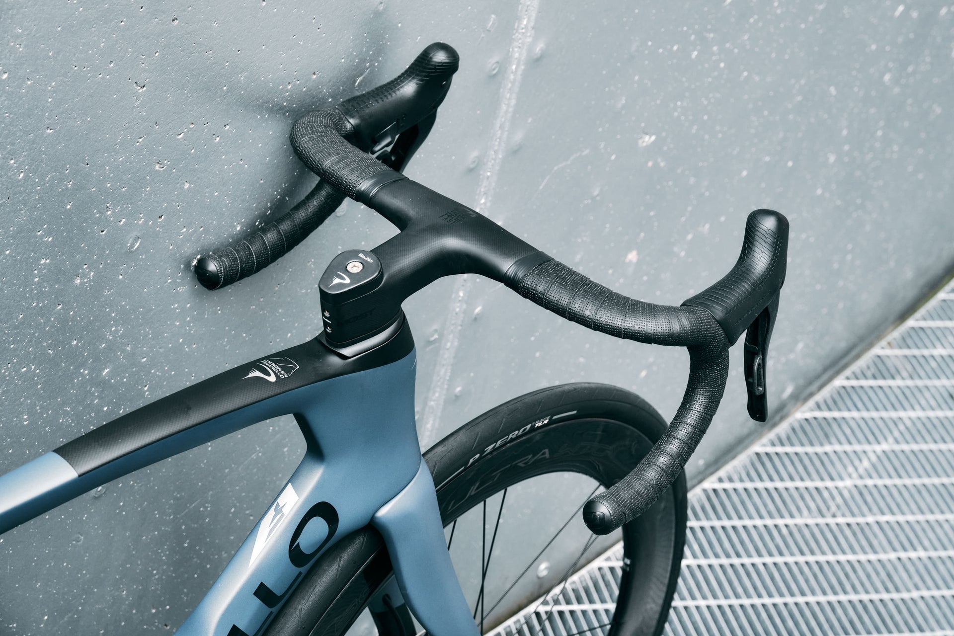 Close-up of the integrated MOST carbon handlebar and clean aero cockpit setup on the Pinarello Dogma F Luxter Grey Matte complete bicycle by Cicli Corsa.