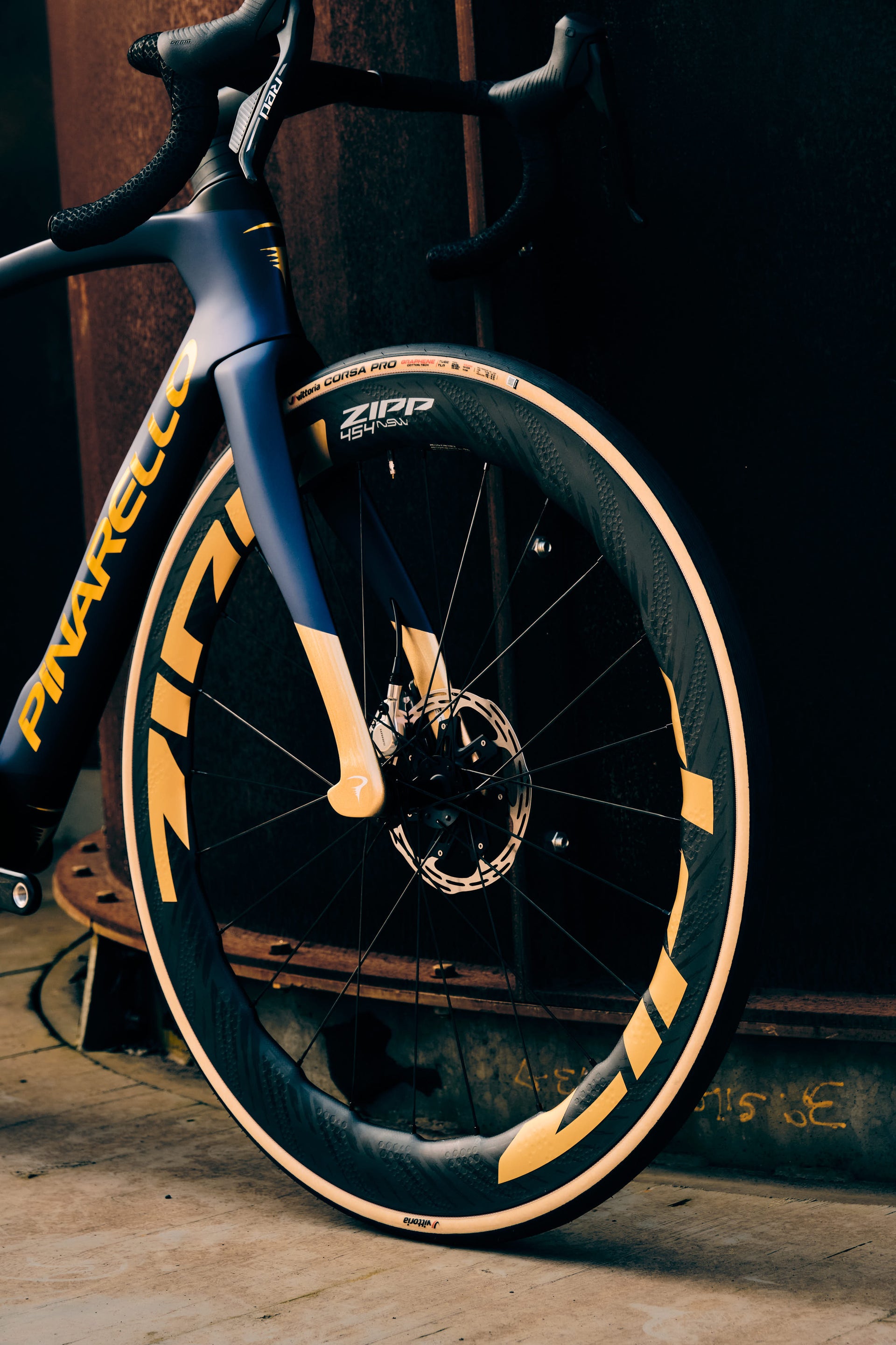 Zipp 454 NSW carbon wheels with SawTooth rim profile and Vittoria Corsa Pro tires on the Pinarello Dogma F complete bicycle by Cicli Corsa.