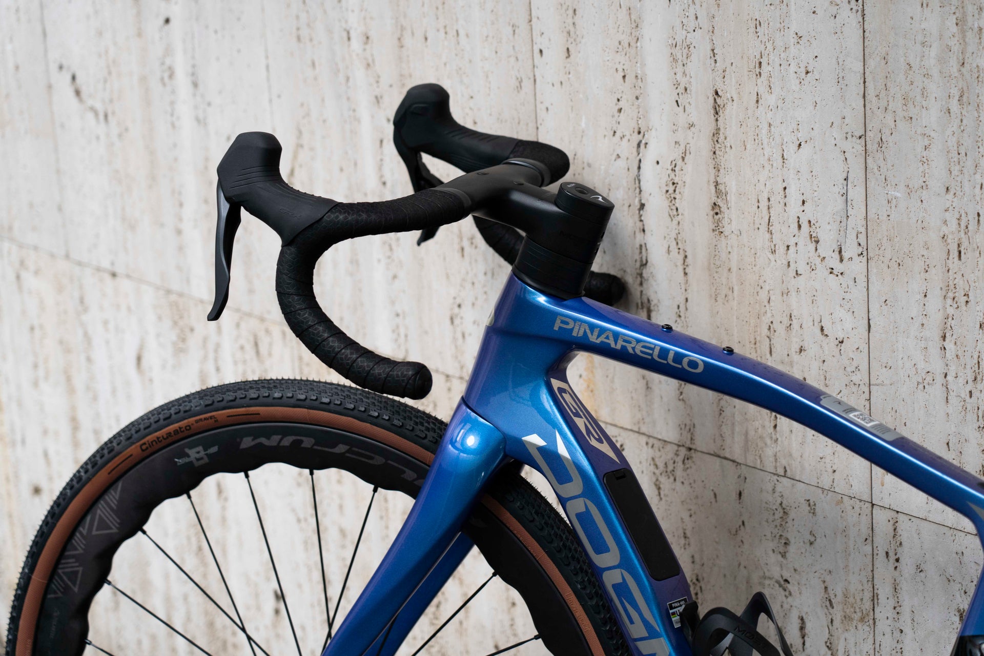 Close-up of the integrated MOST carbon gravel handlebar and clean cockpit setup on the Pinarello Dogma GR Luxter Blue complete bicycle by Cicli Corsa.
