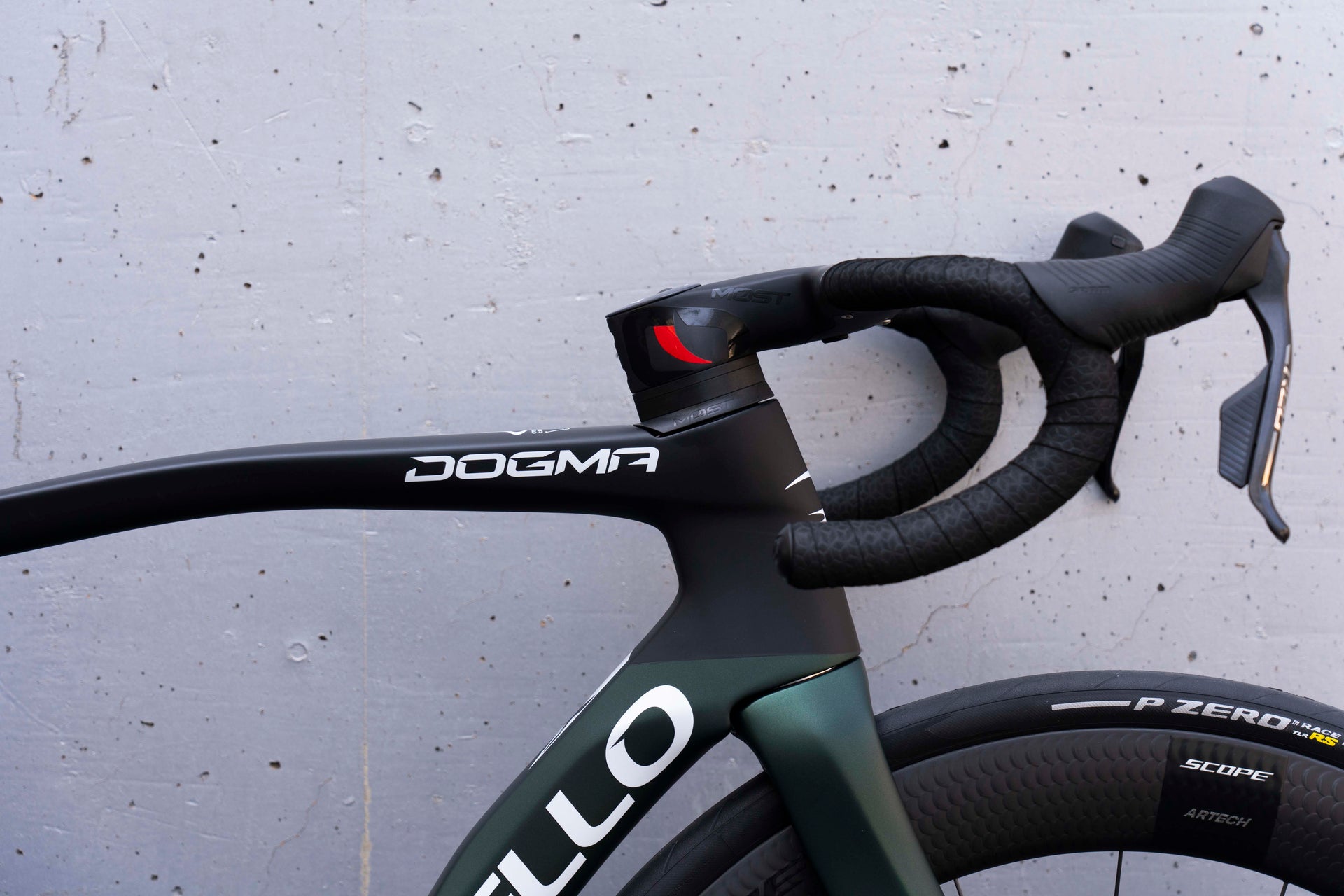 Close-up of the integrated MOST carbon handlebar and clean cockpit setup on the Pinarello Dogma X Xolar Green complete bicycle by Cicli Corsa.