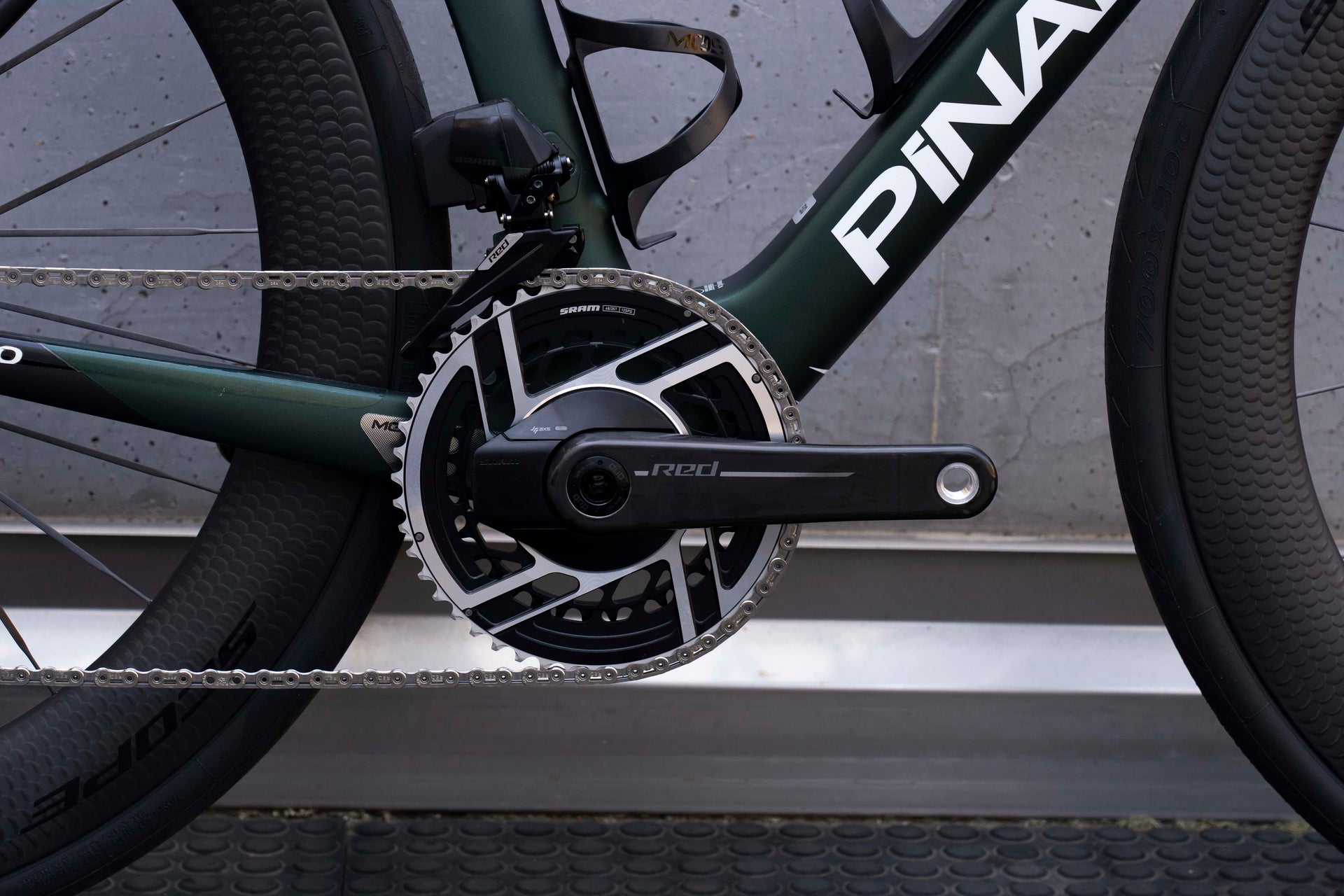 SRAM Red AXS carbon road crankset close-up on the premium Pinarello Dogma X endurance complete bicycle by Cicli Corsa.