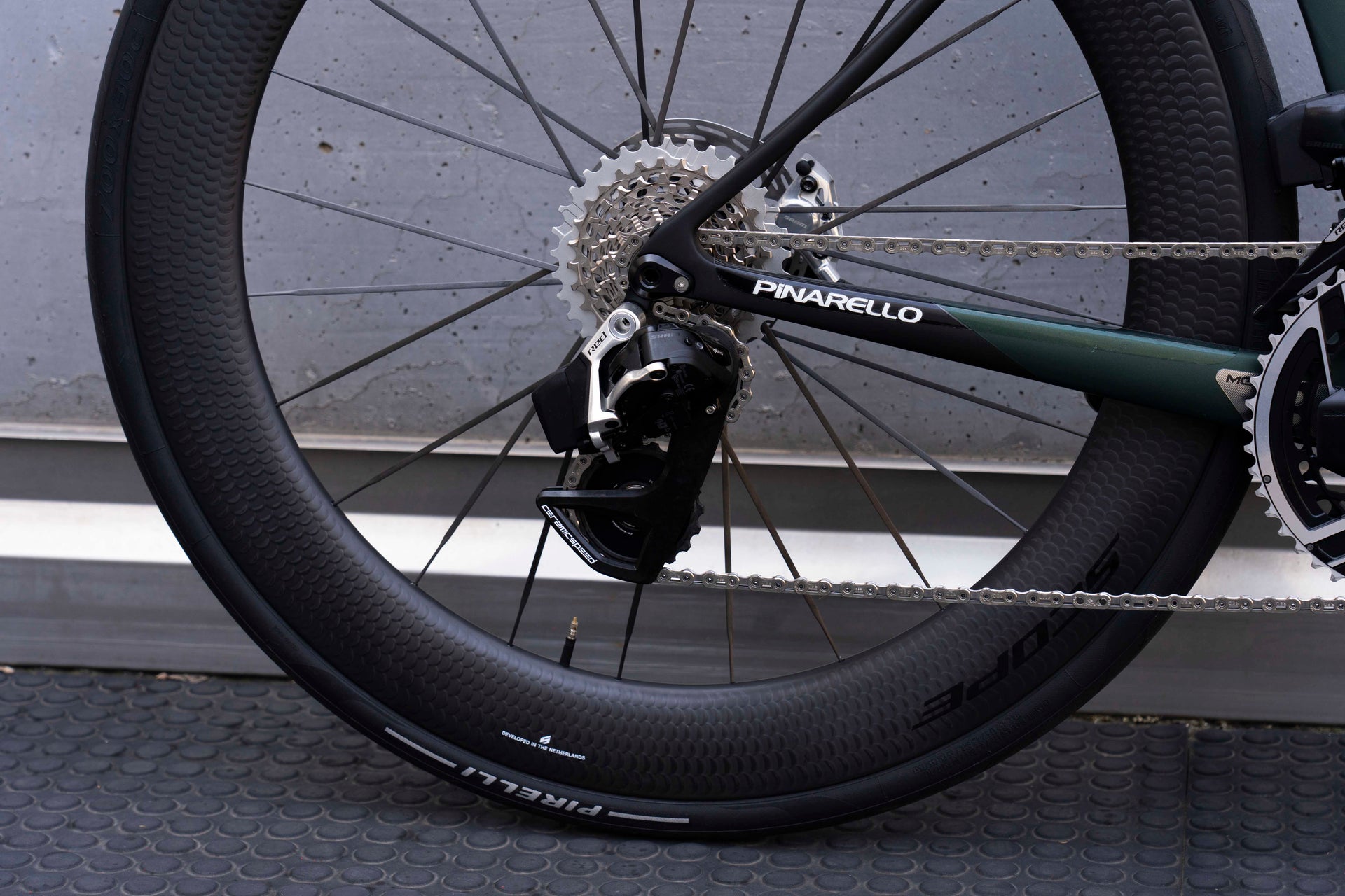 SRAM Red AXS wireless electronic rear derailleur and 12-speed cassette on the Pinarello Dogma X Xolar Green complete bicycle by Cicli Corsa.