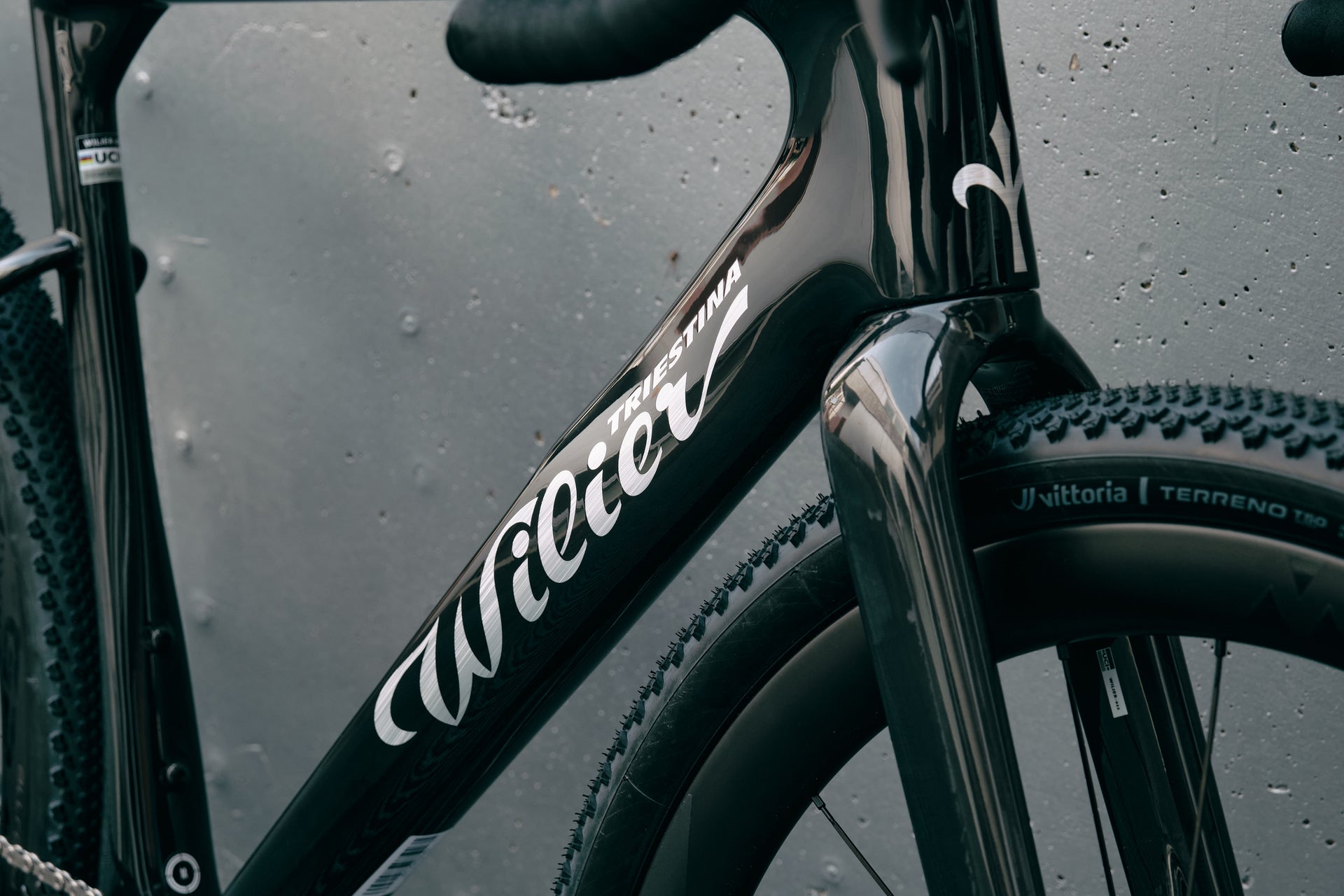 Wilier Triestina branding on the down tube highlighting the premium Glitch Black ID2 paint finish on the Rave SLR complete bicycle by Cicli Corsa.