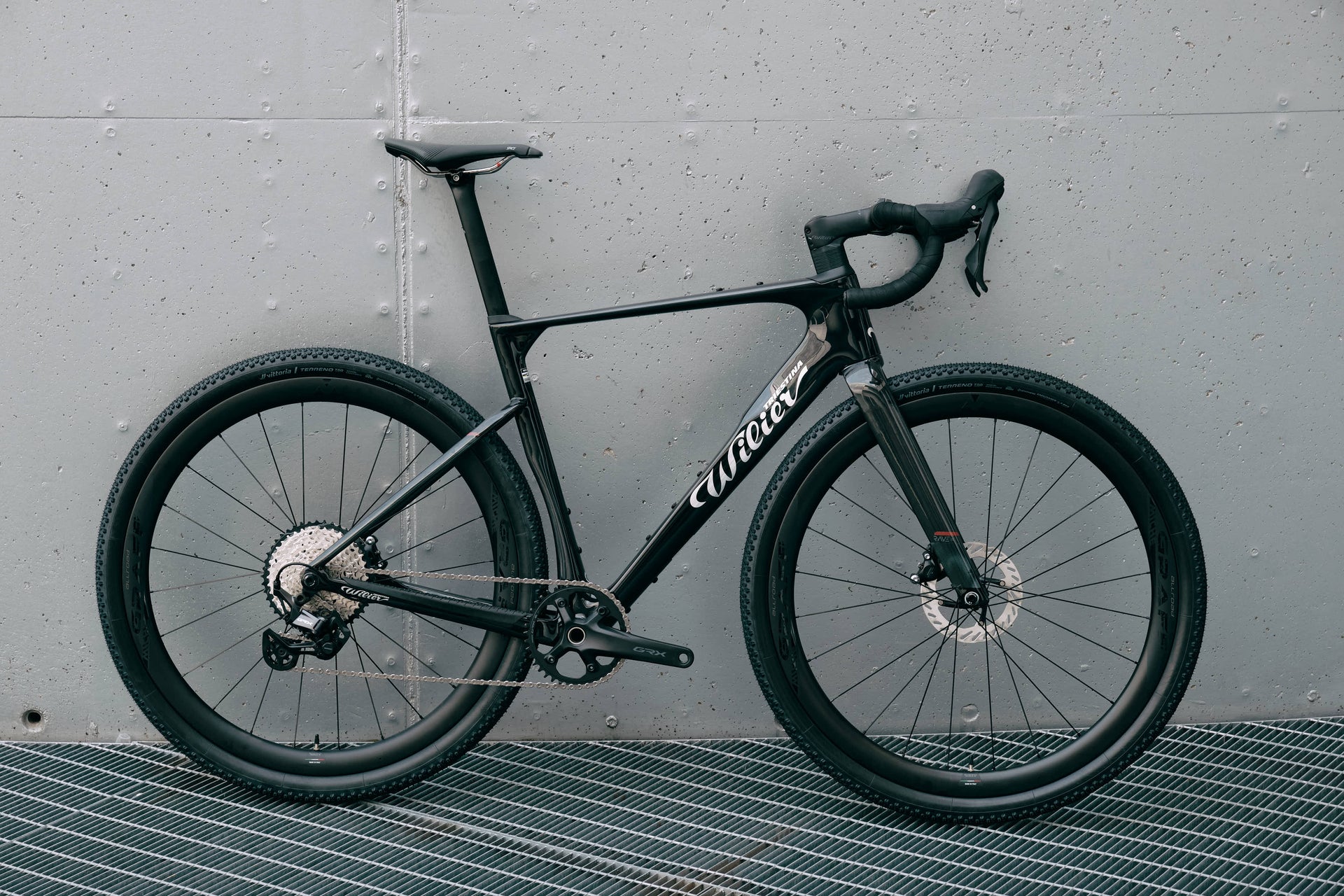Drive side view of the Wilier Triestina Rave SLR Glitch Black complete bicycle with Shimano GRX drivetrain and Miche Graff Allroad wheels, custom built by Cicli Corsa.